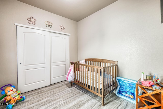 12616 Blazing Star Dr, El Paso, TX 79928 - bedroom with light wood-type flooring, a closet, and a nursery area