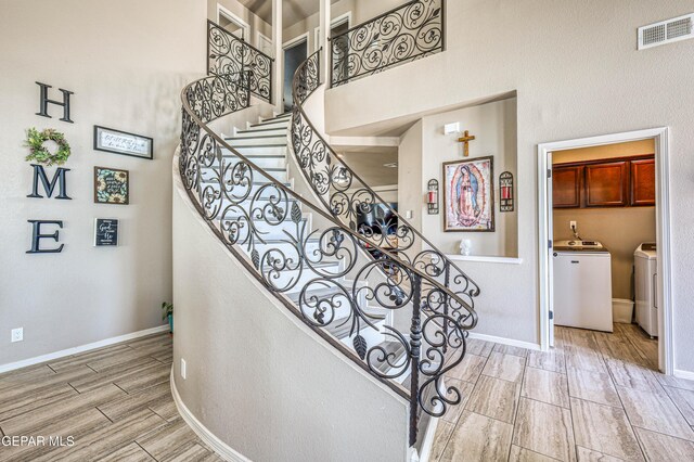 12616 Blazing Star Dr, El Paso, TX 79928 - stairway with washer and dryer, wood tiled floors, and a high ceiling