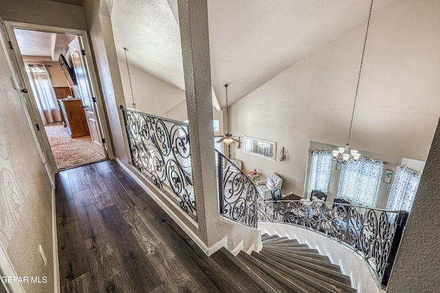 12616 Blazing Star Dr, El Paso, TX 79928 - stairs featuring wood finished floors, a chandelier, ceiling fan, and high vaulted ceiling