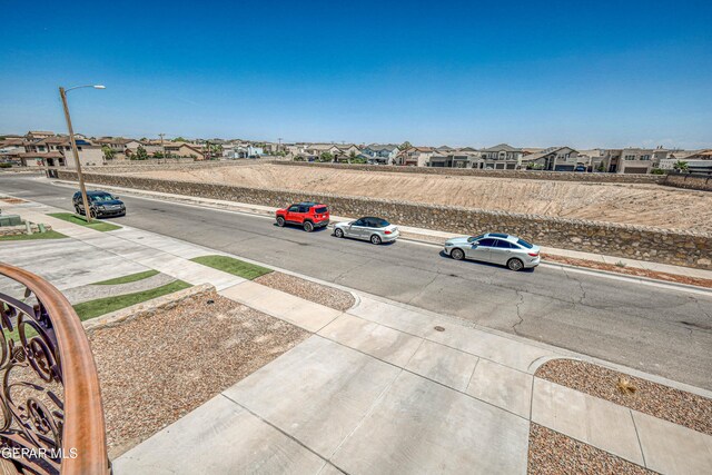 12616 Blazing Star Dr, El Paso, TX 79928 - view of road with sidewalks, street lights, a residential view, and curbs