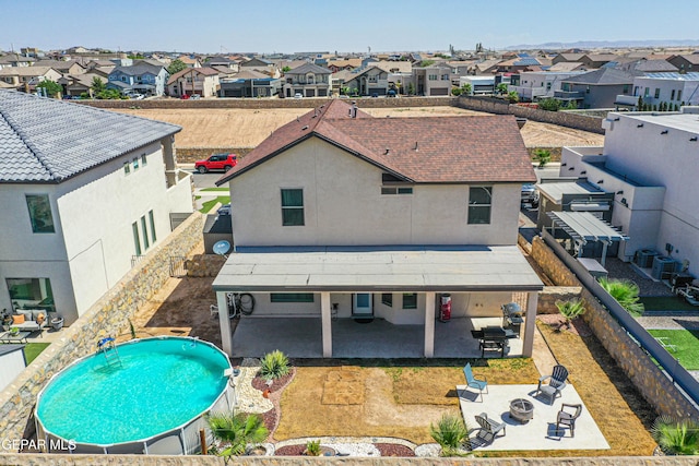 12616 Blazing Star Dr, El Paso, TX 79928 - rear view of house featuring a residential view, a patio, stucco siding, and a fenced backyard