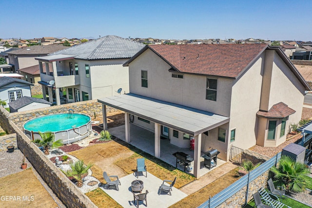 12616 Blazing Star Dr, El Paso, TX 79928 - rear view of property featuring a residential view, stucco siding, a fenced backyard, a patio, and a balcony