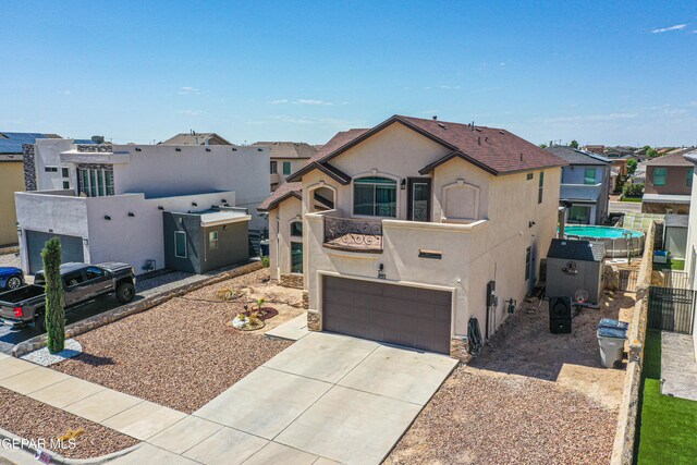 12616 Blazing Star Dr, El Paso, TX 79928 - view of front of house featuring stucco siding, driveway, a balcony, and a residential view