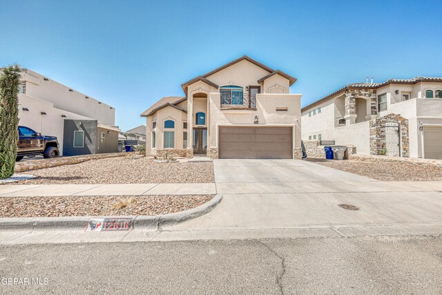 12616 Blazing Star Dr, El Paso, TX 79928 - view of front facade with stucco siding, driveway, an attached garage, and stone siding