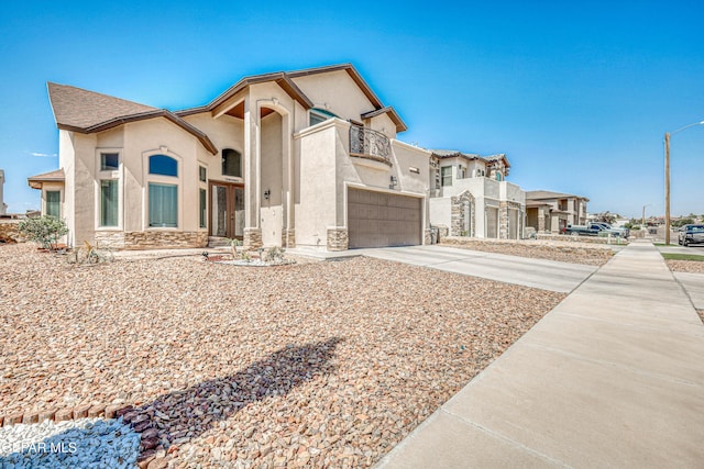 12616 Blazing Star Dr, El Paso, TX 79928 - view of front facade with a garage, stucco siding, concrete driveway, stone siding, and a balcony