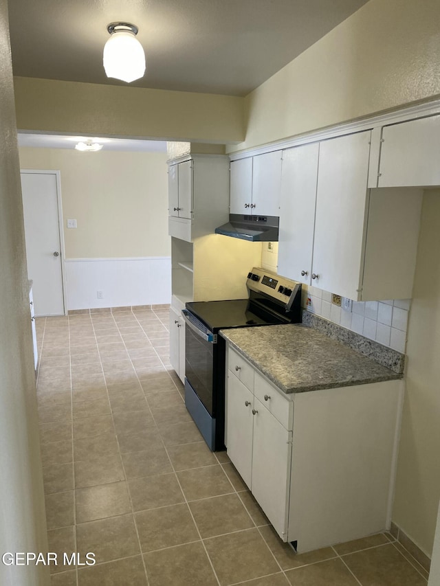 5109 Yvette Ave, El Paso, TX 79924 - kitchen featuring electric range oven, under cabinet range hood, tile patterned floors, and white cabinets