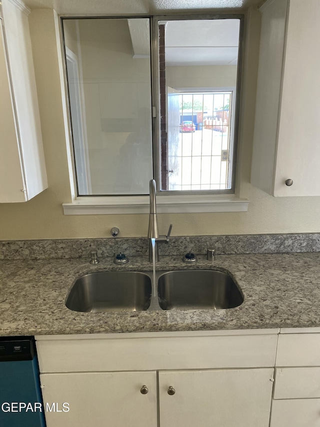 5109 Yvette Ave, El Paso, TX 79924 - kitchen view of dishwashing machine, white cabinetry, and stone countertops