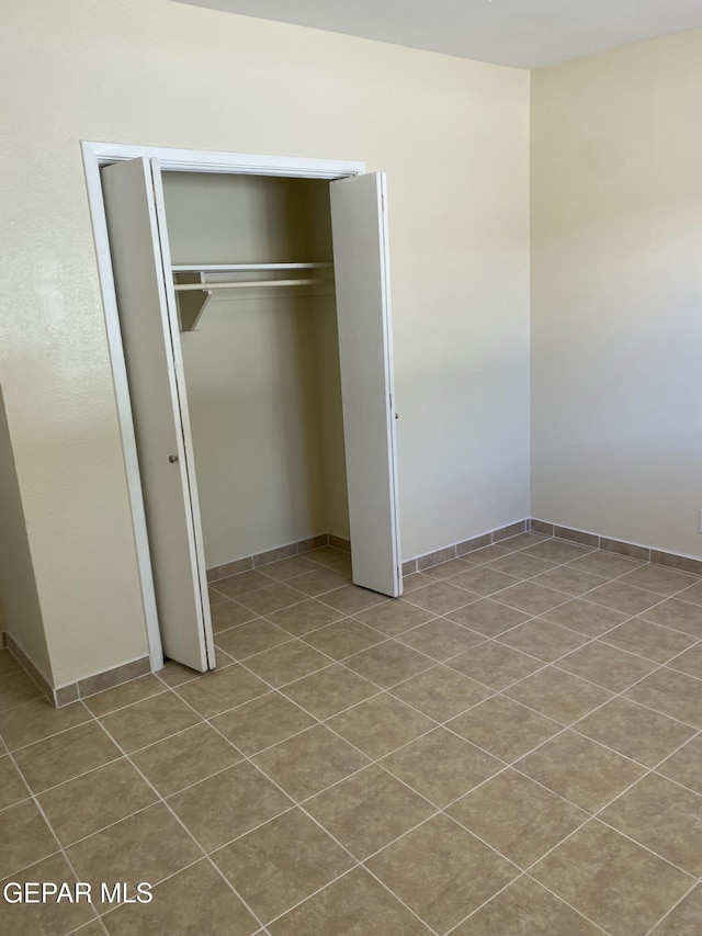5109 Yvette Ave, El Paso, TX 79924 - unfurnished bedroom featuring a closet and tile patterned floors