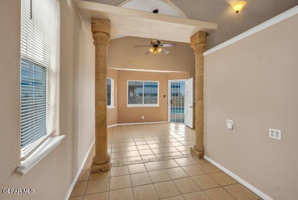 9813 La Morenita Cir, El Paso, TX 79927 - empty room with ornate columns, ceiling fan, healthy amount of natural light, light tile patterned flooring, and lofted ceiling
