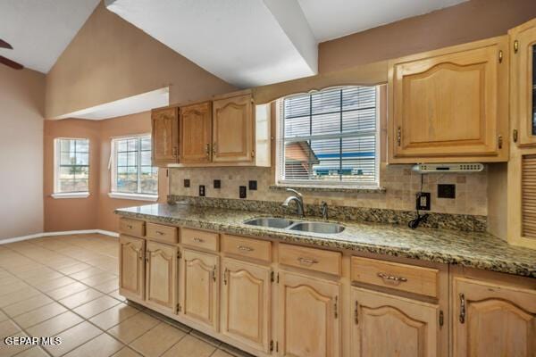 9813 La Morenita Cir, El Paso, TX 79927 - kitchen with vaulted ceiling, backsplash, light tile patterned floors, light brown cabinetry, and a ceiling fan