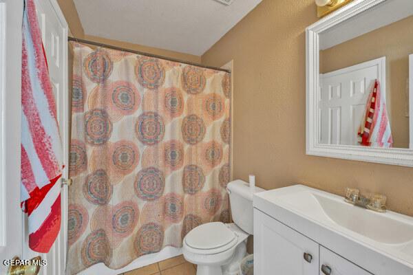 9813 La Morenita Cir, El Paso, TX 79927 - full bathroom featuring vanity, tile patterned floors, and a shower with curtain
