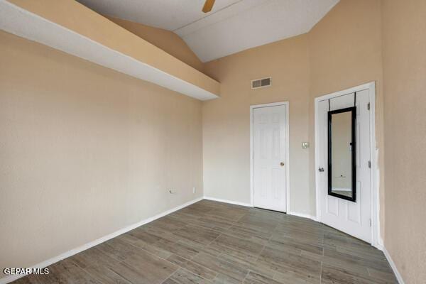 9813 La Morenita Cir, El Paso, TX 79927 - empty room featuring lofted ceiling, wood finished floors, and a ceiling fan