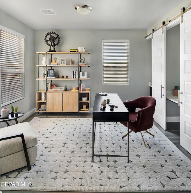 2241 Rocky Terrace Place, El Paso, TX 79911 - office area featuring a barn door and healthy amount of natural light