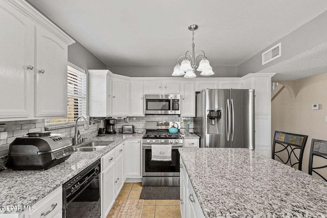 12232 Tierra Rosa Way, El Paso, TX 79938 - kitchen featuring appliances with stainless steel finishes, white cabinetry, and tasteful backsplash