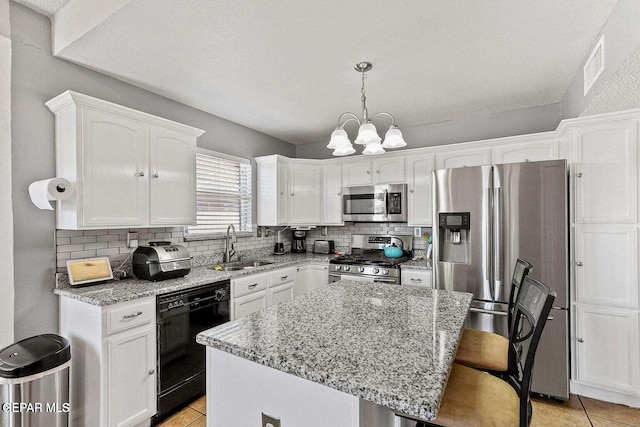 12232 Tierra Rosa Way, El Paso, TX 79938 - kitchen featuring appliances with stainless steel finishes, white cabinets, a chandelier, and light tile patterned flooring