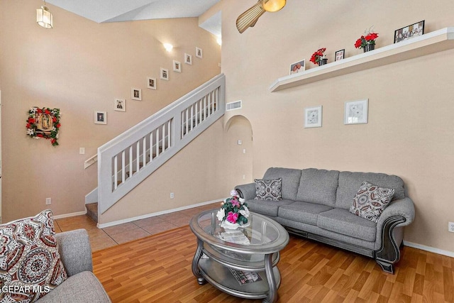 12232 Tierra Rosa Way, El Paso, TX 79938 - living room with stairs, wood finished floors, arched walkways, and vaulted ceiling