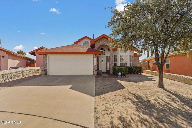 12232 Tierra Rosa Way, El Paso, TX 79938 - view of front of house featuring an attached garage, driveway, and brick siding