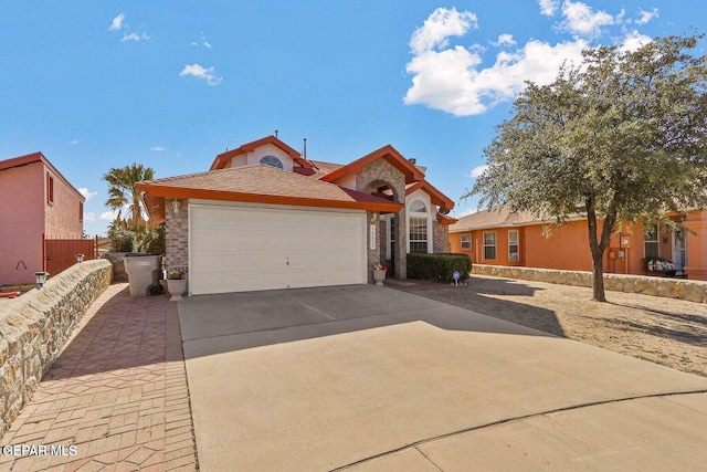 12232 Tierra Rosa Way, El Paso, TX 79938 - view of front of home featuring concrete driveway, a garage, and stone siding
