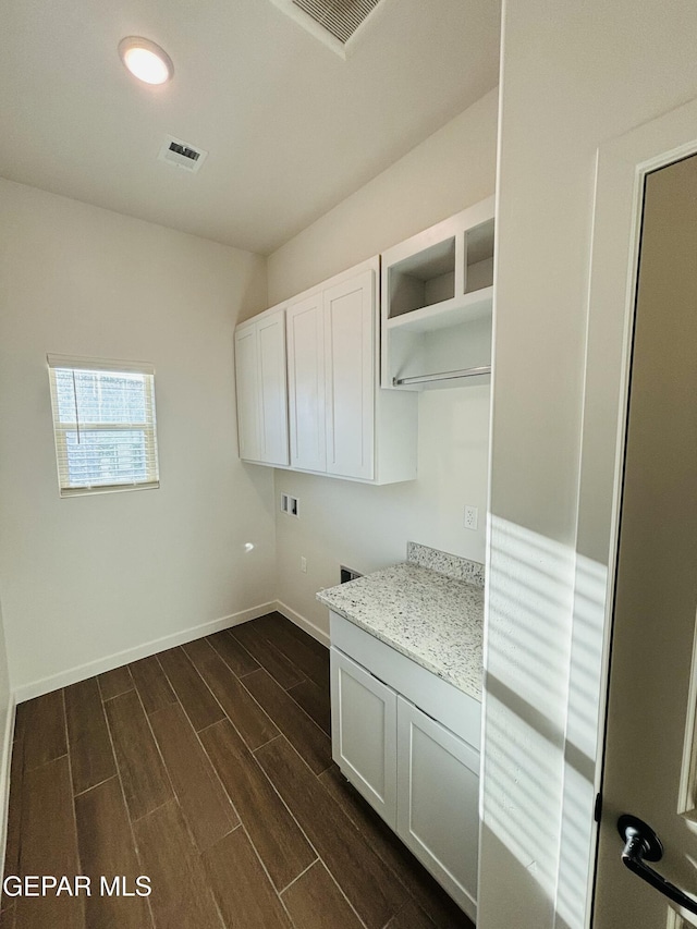 812 Acton St, El Paso, TX 79928 - washroom with cabinet space, hookup for a washing machine, and dark wood finished floors