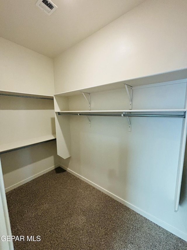 812 Acton St, El Paso, TX 79928 - spacious closet featuring dark colored carpet