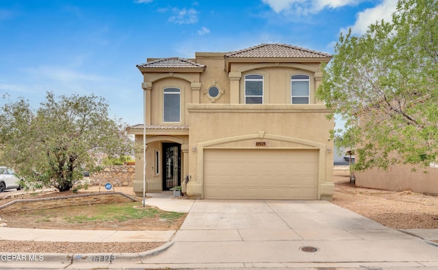 10925 Ray Mena Ln, El Paso, TX 79934 - mediterranean / spanish house with a tile roof, stucco siding, a garage, and driveway