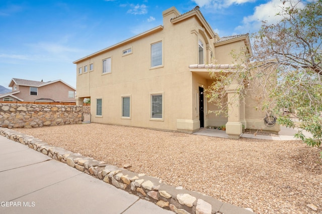 10925 Ray Mena Ln, El Paso, TX 79934 - rear view of house with stucco siding, a chimney, and a patio area