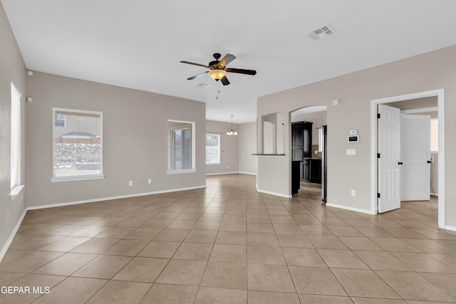 10925 Ray Mena Ln, El Paso, TX 79934 - unfurnished living room featuring a ceiling fan, arched walkways, light tile patterned flooring, and a chandelier