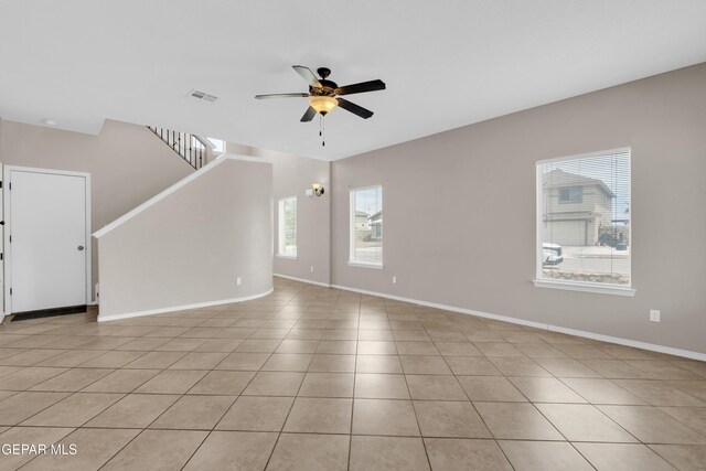 10925 Ray Mena Ln, El Paso, TX 79934 - unfurnished living room featuring ceiling fan, light tile patterned floors, and stairway