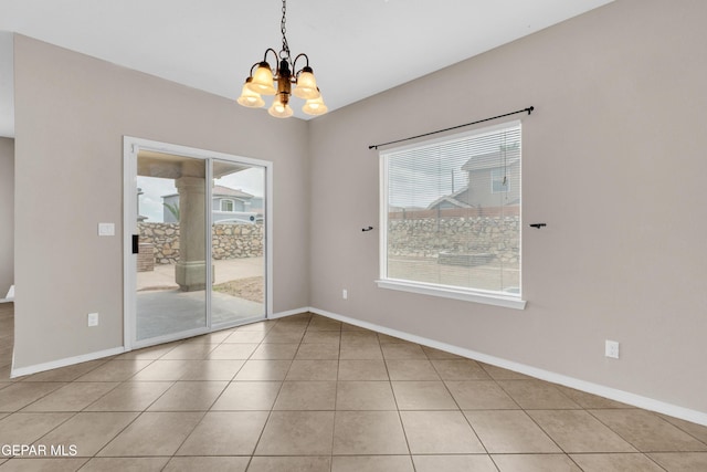 10925 Ray Mena Ln, El Paso, TX 79934 - tiled empty room featuring healthy amount of natural light and a chandelier