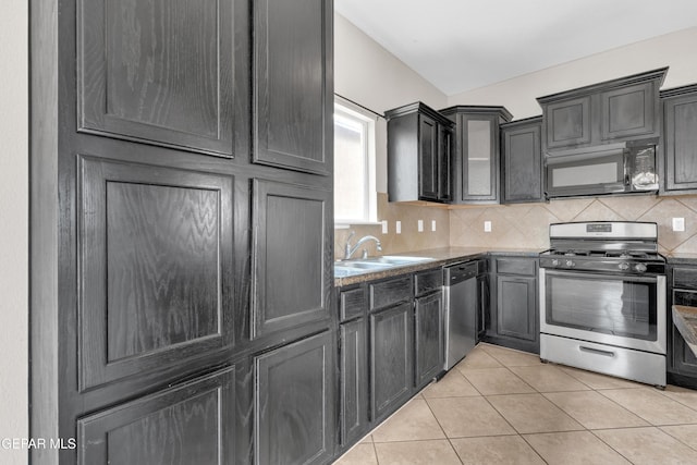 10925 Ray Mena Ln, El Paso, TX 79934 - kitchen with stainless steel appliances, tasteful backsplash, and light tile patterned floors