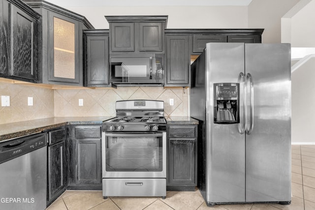10925 Ray Mena Ln, El Paso, TX 79934 - kitchen featuring stainless steel appliances, dark stone counters, and light tile patterned floors