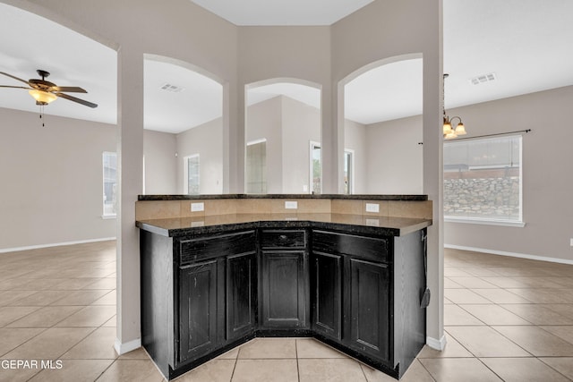 10925 Ray Mena Ln, El Paso, TX 79934 - kitchen featuring dark cabinetry, light tile patterned flooring, and healthy amount of natural light