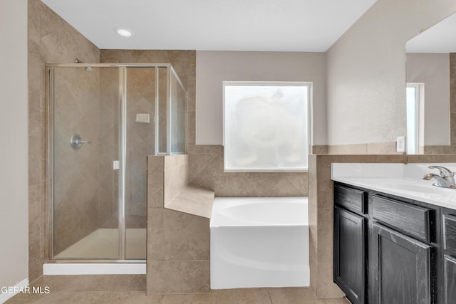 10925 Ray Mena Ln, El Paso, TX 79934 - full bath with vanity, a shower stall, a bath, tile patterned floors, and tile walls