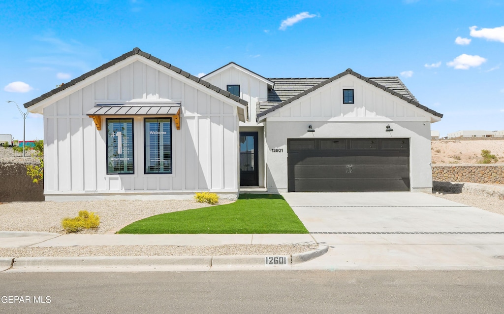 244 Park Vista Pl, Horizon City, TX 79928 - modern farmhouse style home featuring board and batten siding, a garage, concrete driveway, and a tile roof