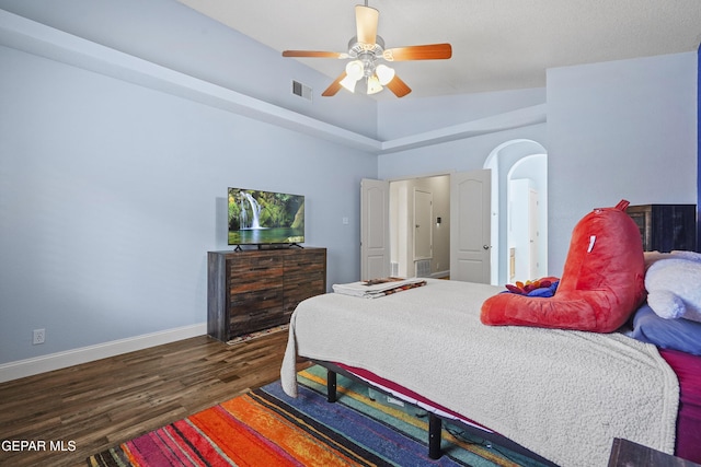 13788 Paseo Verde Dr, El Paso, TX 79928 - bedroom with wood finished floors, ceiling fan, and arched walkways