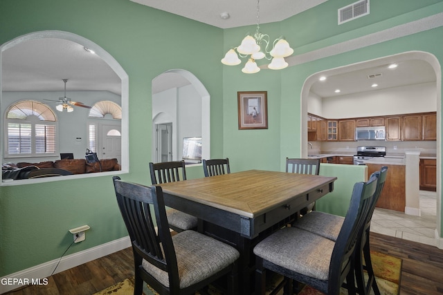 13788 Paseo Verde Dr, El Paso, TX 79928 - dining room with arched walkways, ceiling fan, wood finished floors, a chandelier, and recessed lighting