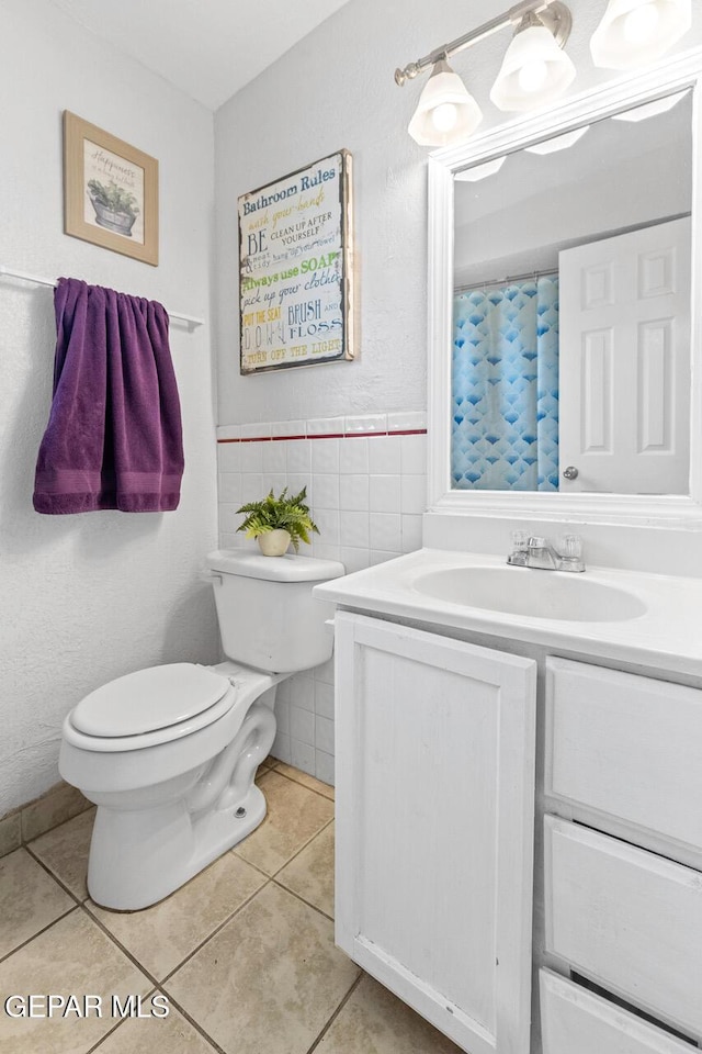 10636 Palomino St, El Paso, TX 79924 - bathroom with vanity, tile patterned flooring, tile walls, and curtained shower