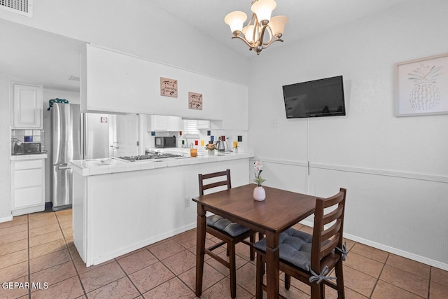10636 Palomino St, El Paso, TX 79924 - dining space with light tile patterned flooring and a chandelier