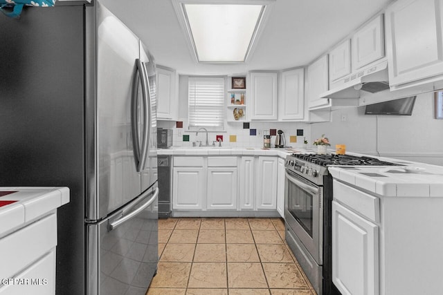 10636 Palomino St, El Paso, TX 79924 - kitchen featuring appliances with stainless steel finishes, tile countertops, under cabinet range hood, and white cabinetry