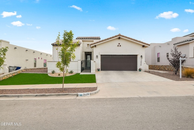 7426 Sidewinder Bend Dr, El Paso, TX 79911 - mediterranean / spanish house featuring a tile roof, an attached garage, stucco siding, concrete driveway, and a front lawn