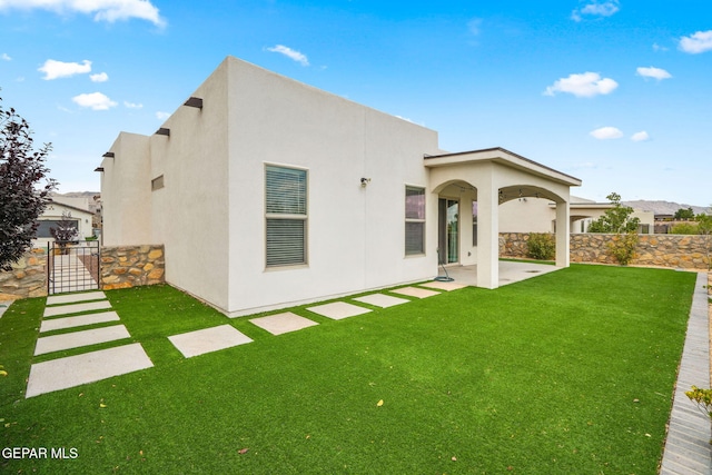 7426 Sidewinder Bend Dr, El Paso, TX 79911 - rear view of house with stucco siding and a patio