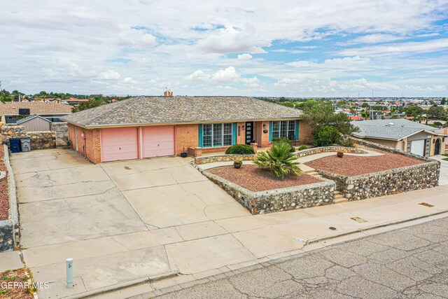 10705 Vista Alegre Dr, El Paso, TX 79935 - ranch-style home featuring an attached garage, brick siding, and driveway