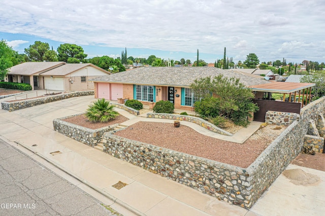 10705 Vista Alegre Dr, El Paso, TX 79935 - view of front of house with driveway, a garage, brick siding, and a shingled roof