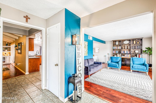 10705 Vista Alegre Dr, El Paso, TX 79935 - living room featuring a textured ceiling, built in features, and wood finished floors