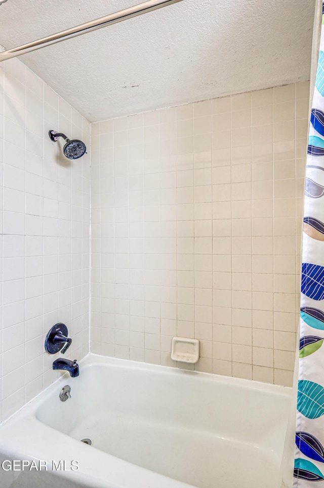 10705 Vista Alegre Dr, El Paso, TX 79935 - bathroom with shower / bath combination with curtain and a textured ceiling