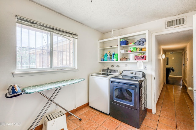 10705 Vista Alegre Dr, El Paso, TX 79935 - laundry area featuring separate washer and dryer, light tile patterned floors, and a textured ceiling