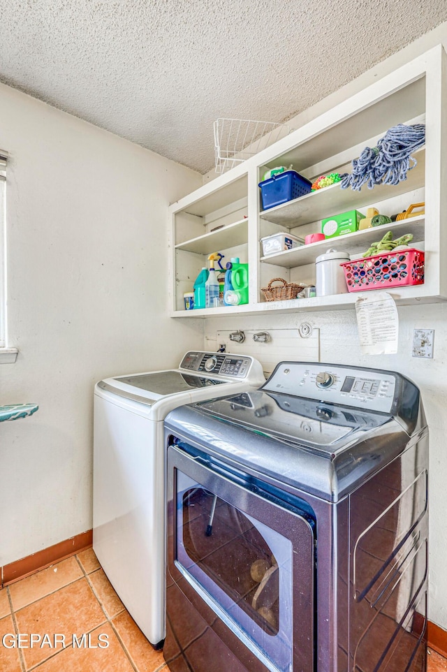 10705 Vista Alegre Dr, El Paso, TX 79935 - washroom with separate washer and dryer, a textured ceiling, and light tile patterned flooring