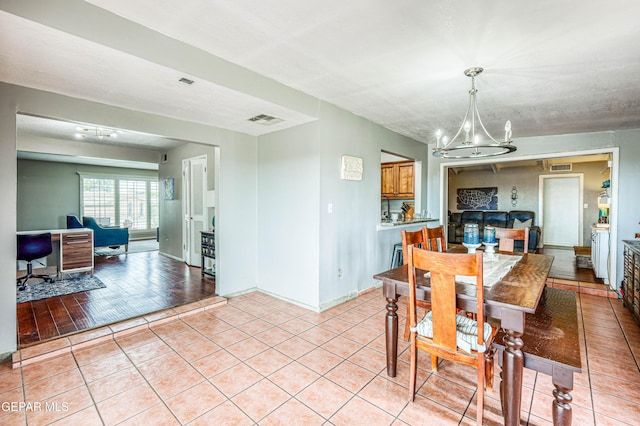 10705 Vista Alegre Dr, El Paso, TX 79935 - dining room featuring a chandelier and light tile patterned floors