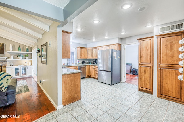 10705 Vista Alegre Dr, El Paso, TX 79935 - kitchen featuring stainless steel appliances, brown cabinetry, recessed lighting, and a textured ceiling