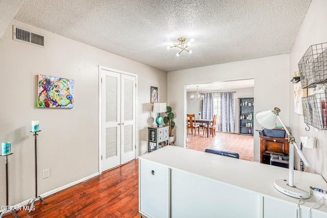 10705 Vista Alegre Dr, El Paso, TX 79935 - home office featuring a chandelier, a textured ceiling, and dark wood finished floors